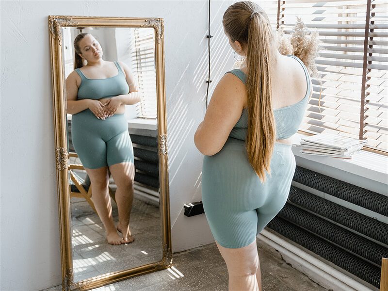 Imagem de mulher se olhando no espelho